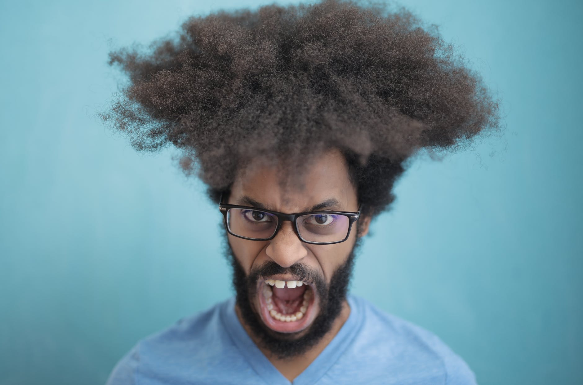 man in blue crew neck shirt wearing black framed eyeglasses