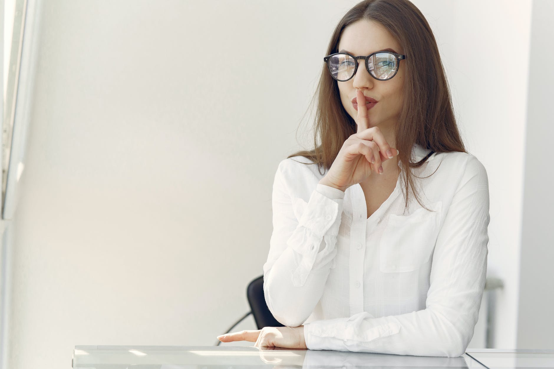 flirty young lady asking to keep secret sitting in office