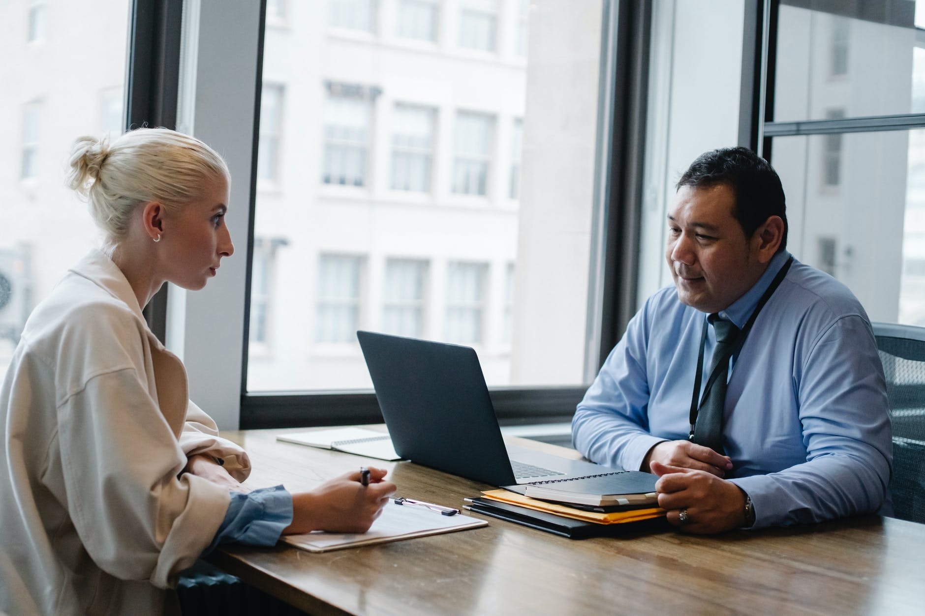 focused ethnic male boss interviewing applicant in office