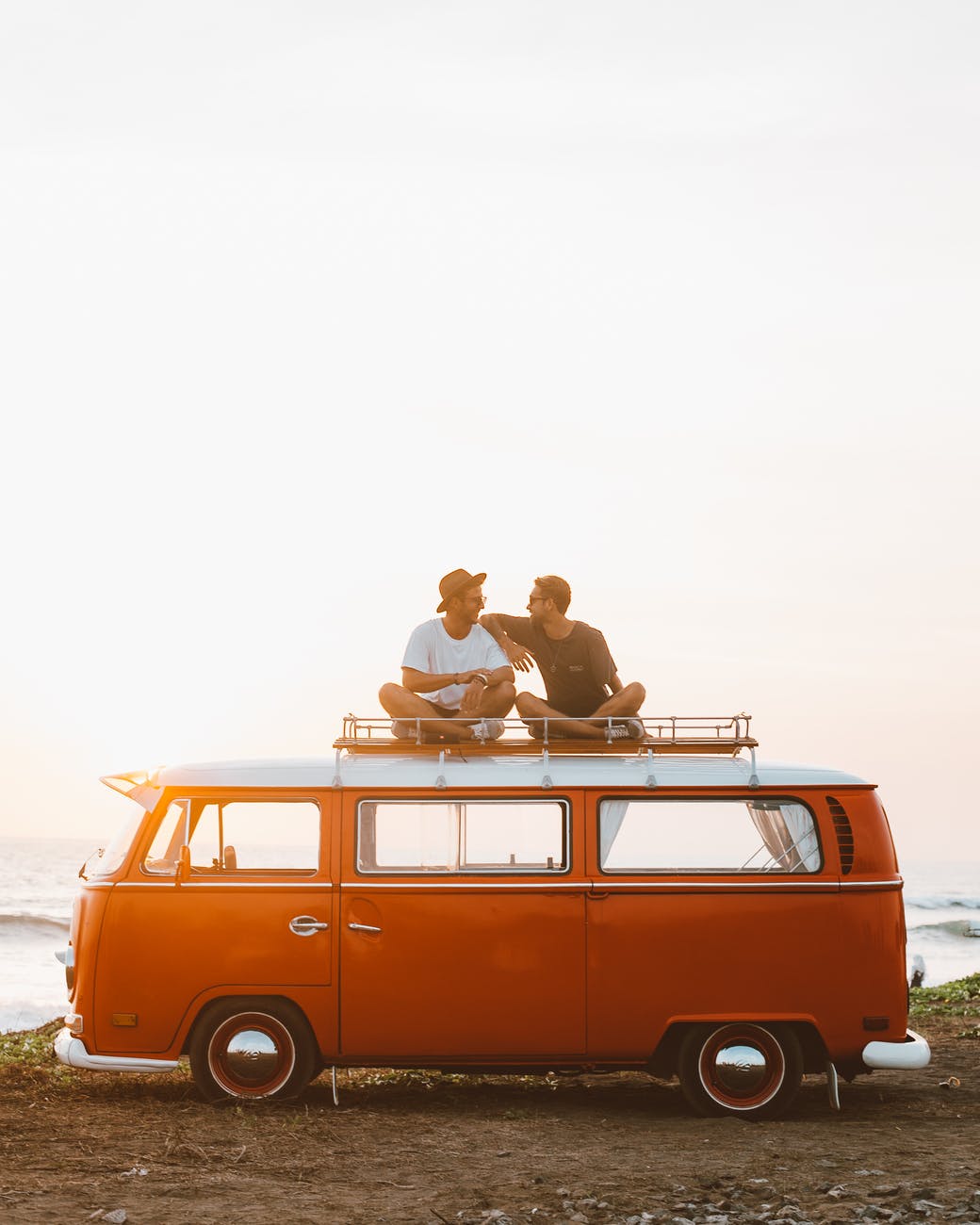 happy friends on camper van roof