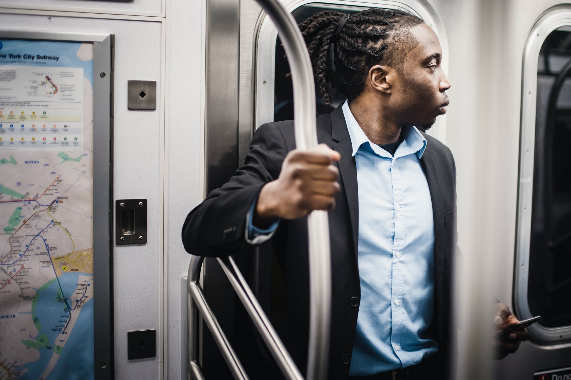 male passenger in formal wear getting home by train