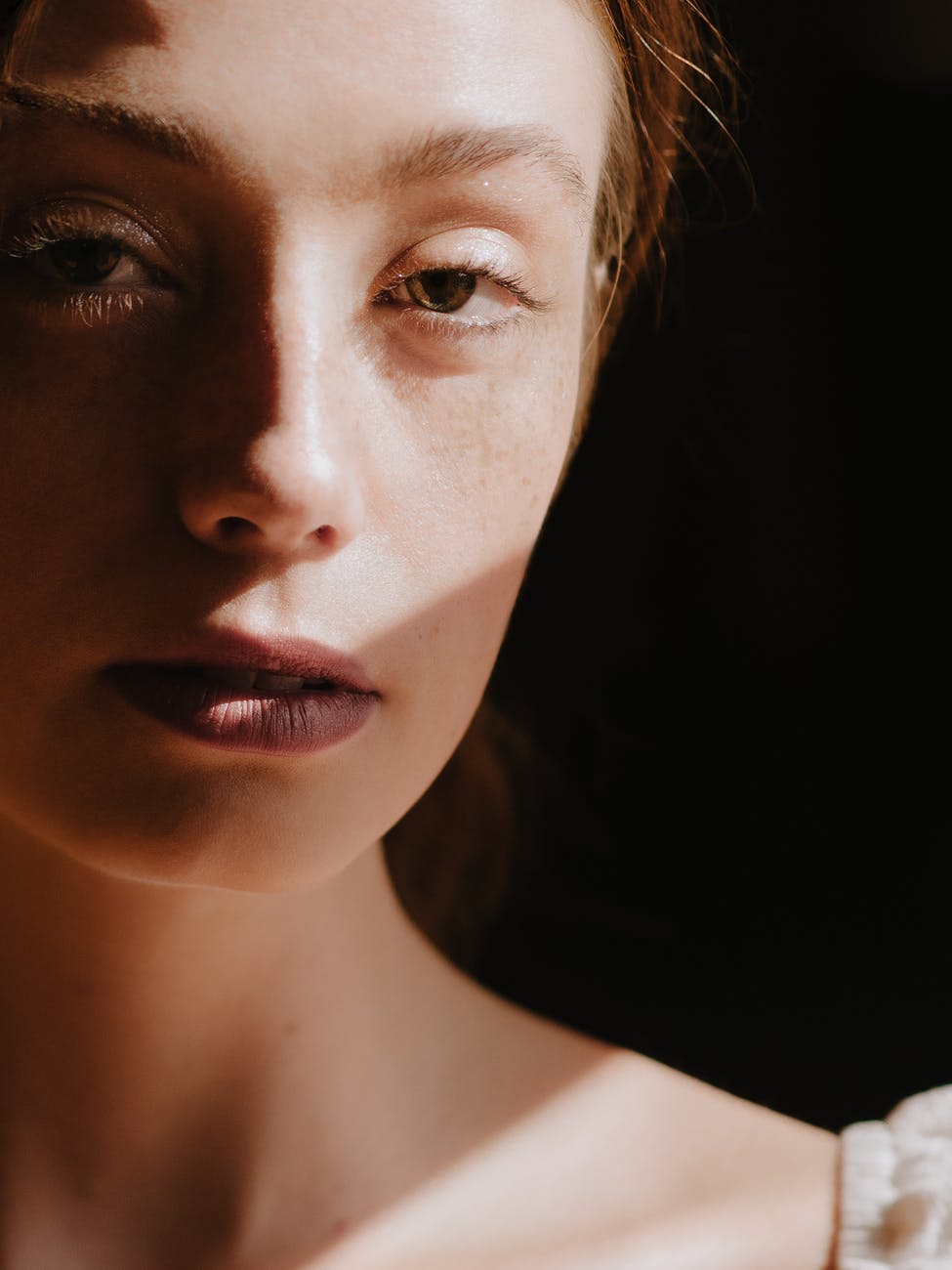 crop attractive young woman in dark room