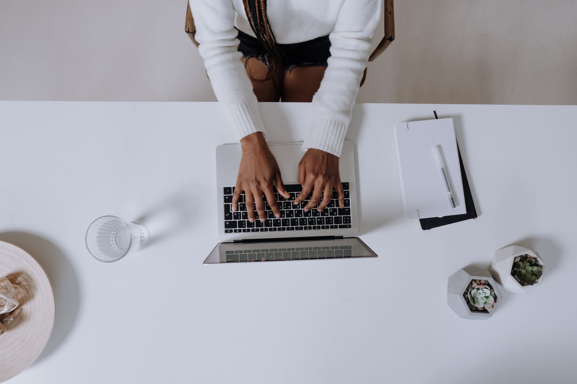 woman in white long sleeve shirt using macbook pro