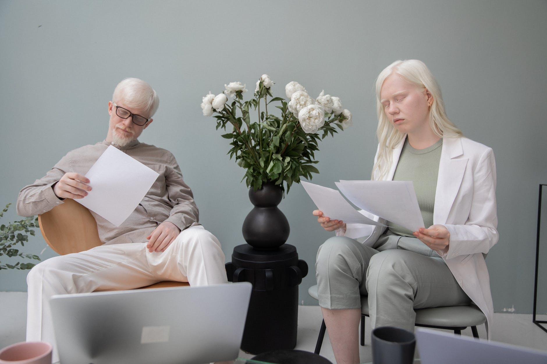 albino coworkers working with documents