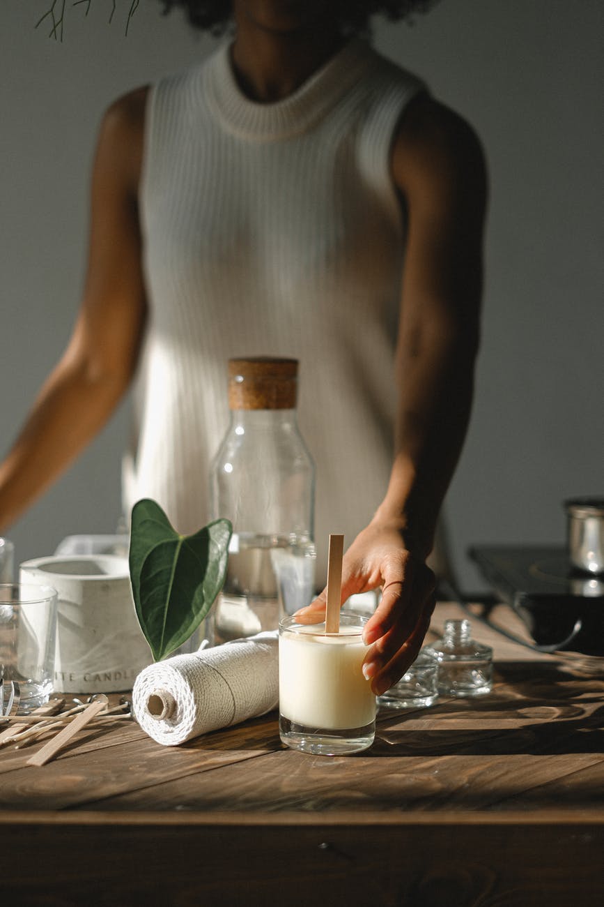 crop black woman with handmade candle