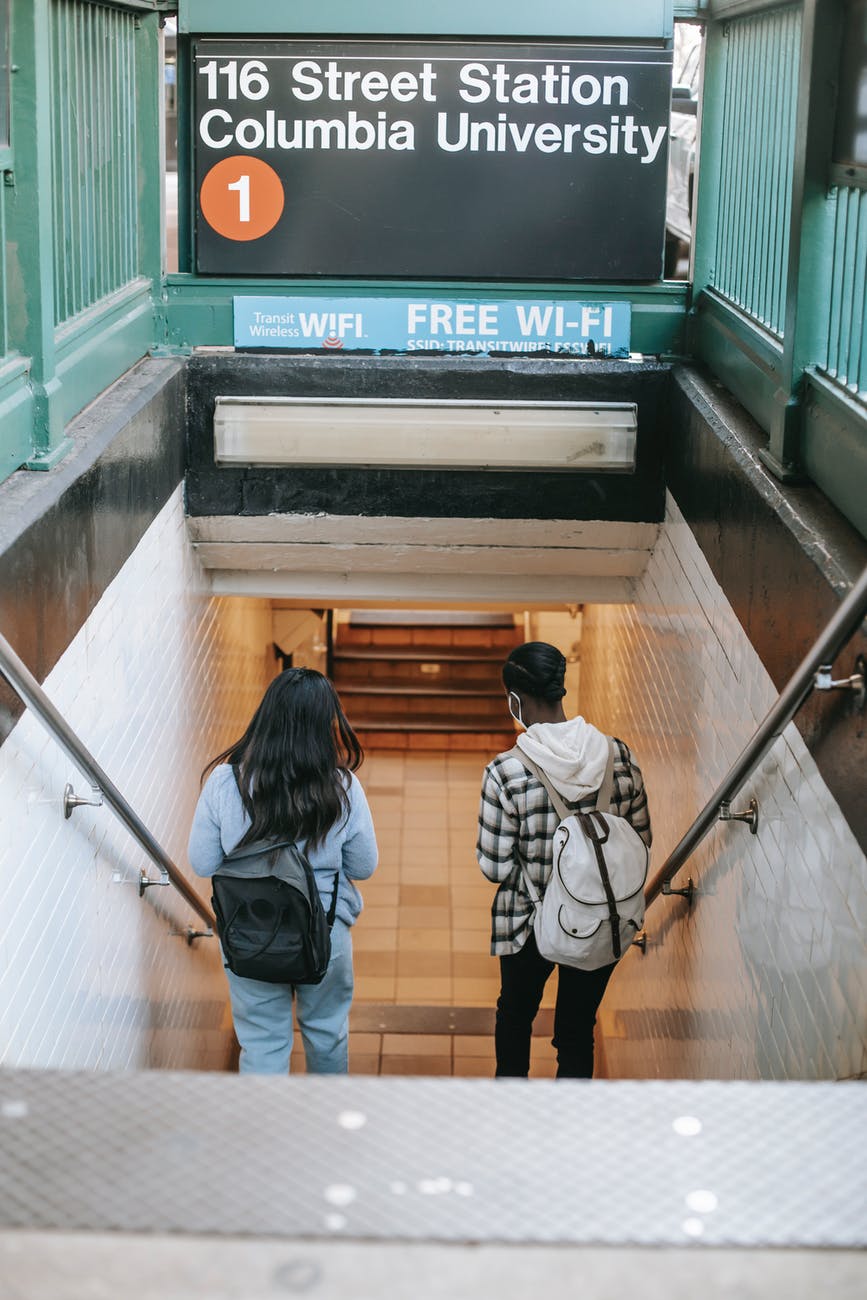 women walking down staircase in underground