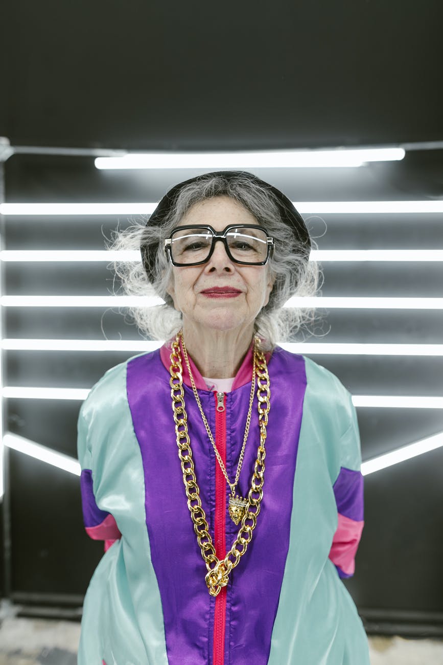 elderly woman wearing colorful outfit with flashy jewelry