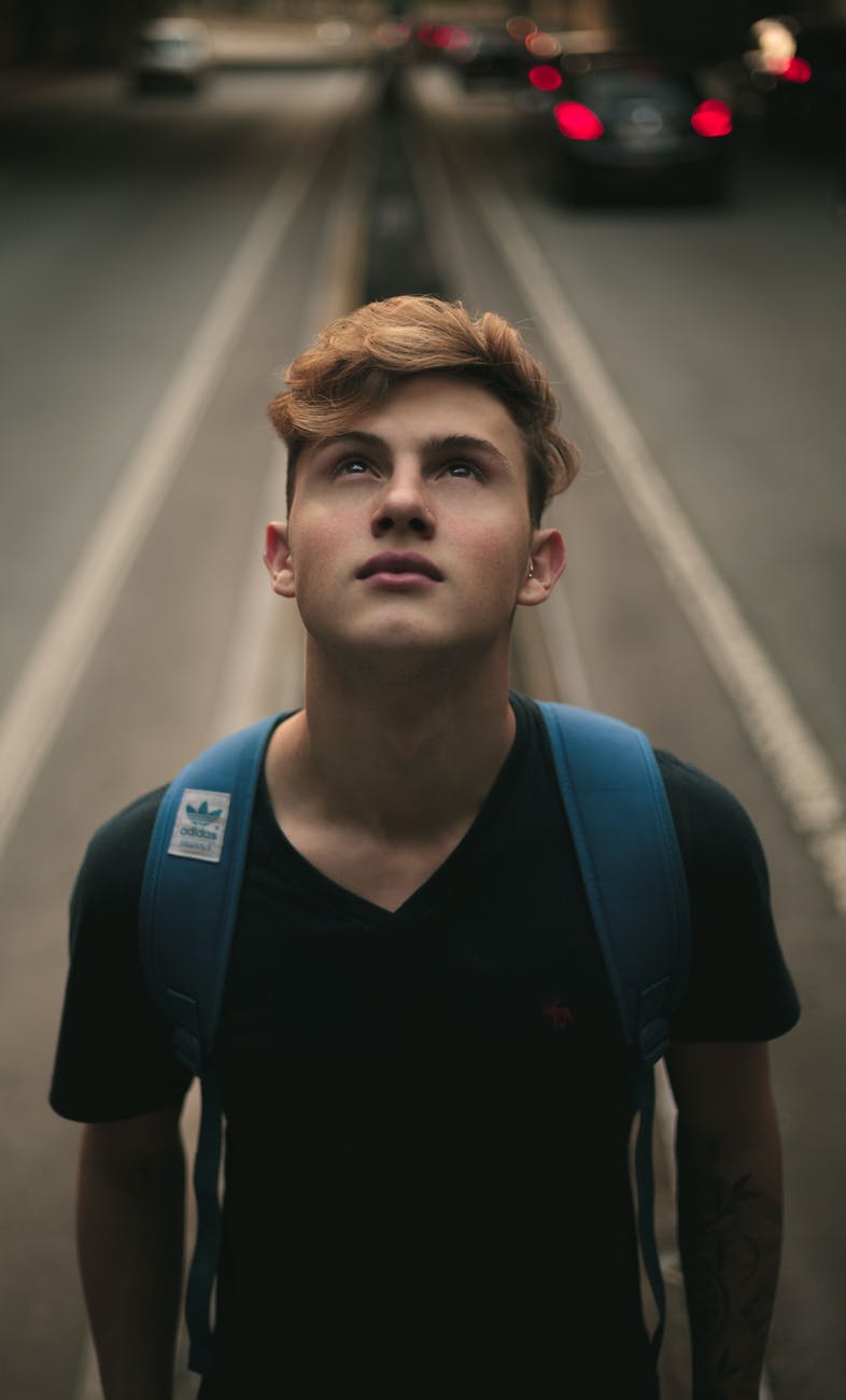 man standing in the middle of road