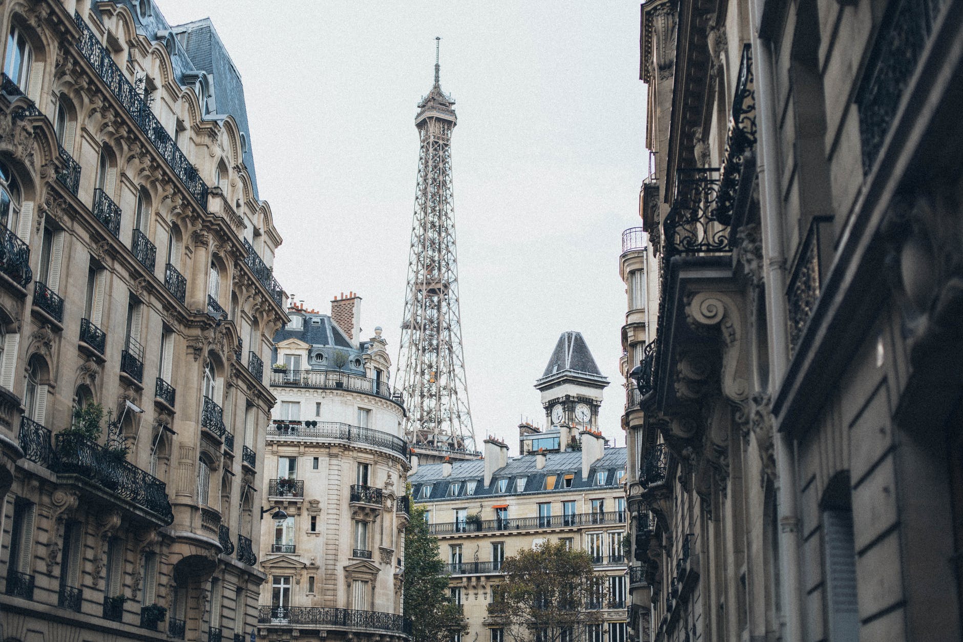 eiffel tower behind buildings