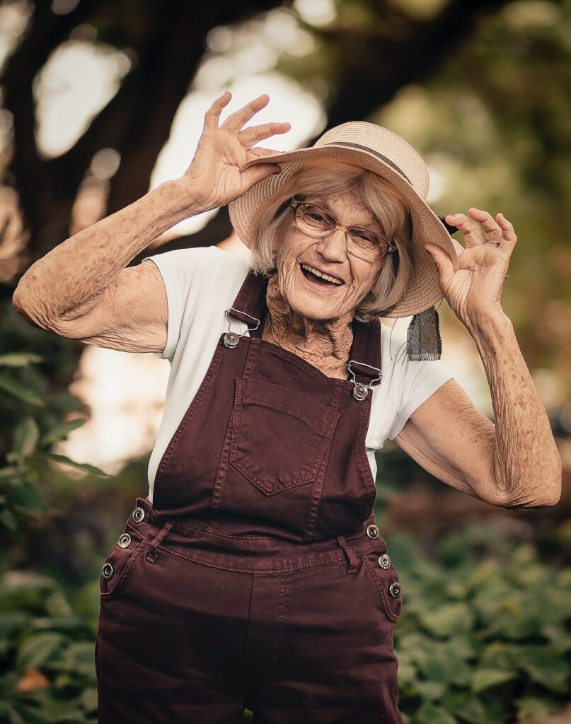 selective focus photography of woman standing near green plant