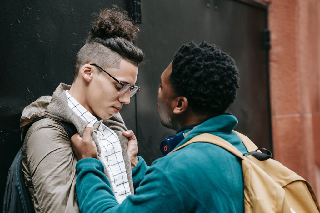 young black male student bullying classmate on street