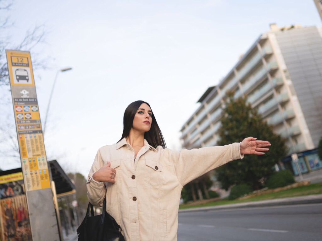 trendy young lady catching cab on city street