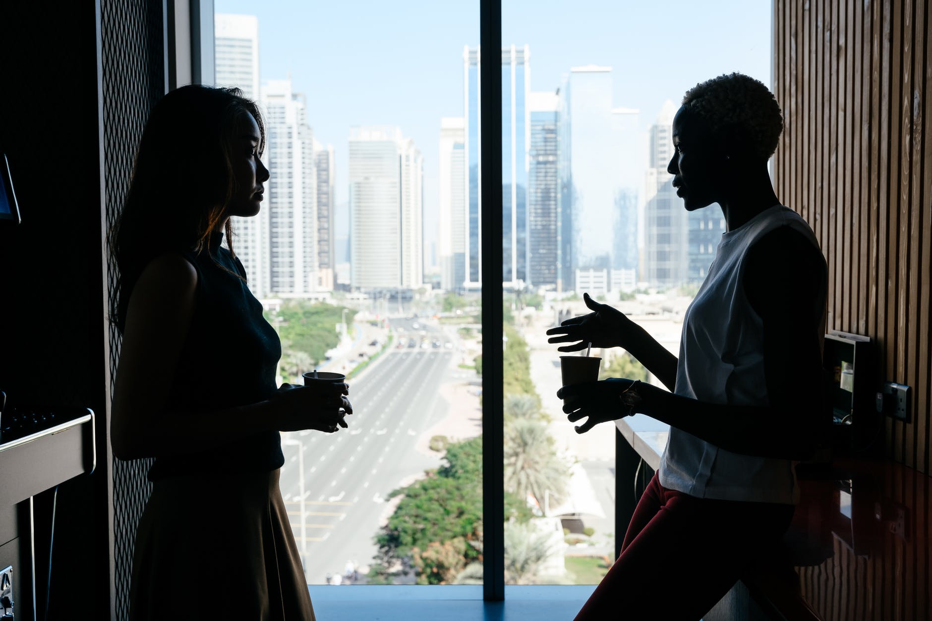 multiethnic women talking about business project in modern office