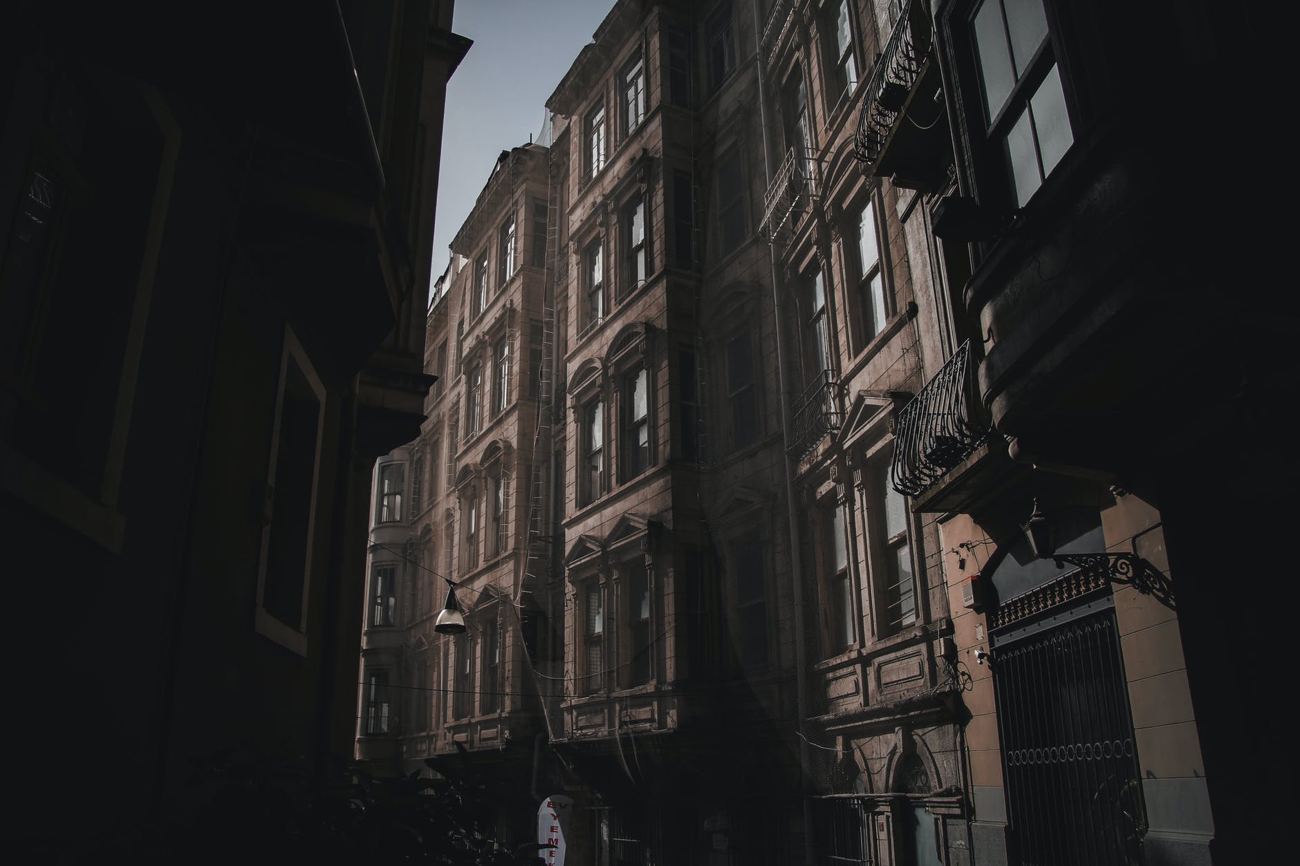 facades of aged buildings on city street