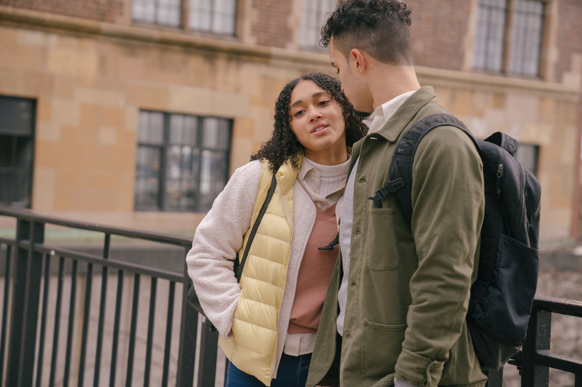 hispanic couple standing in city street near building