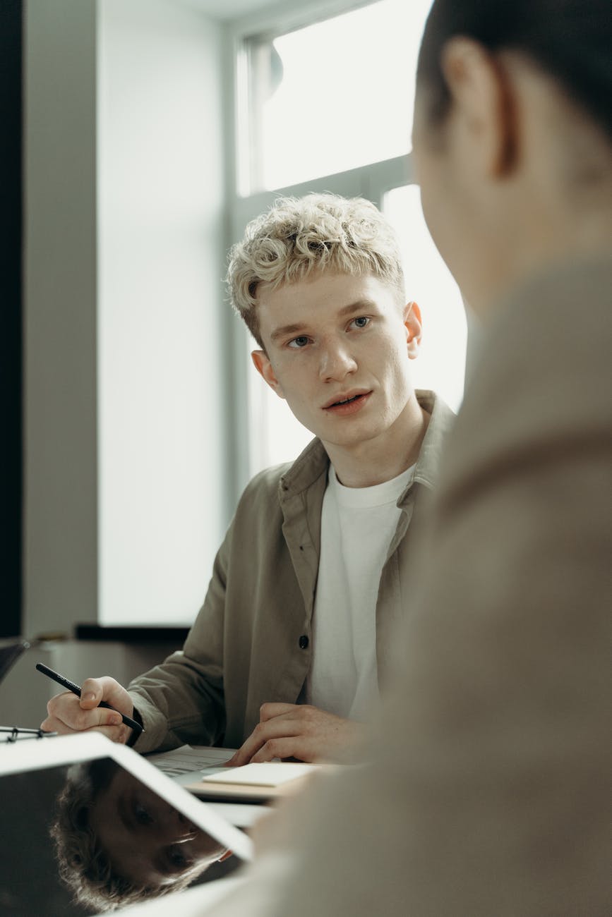 photo of a man holding a pen