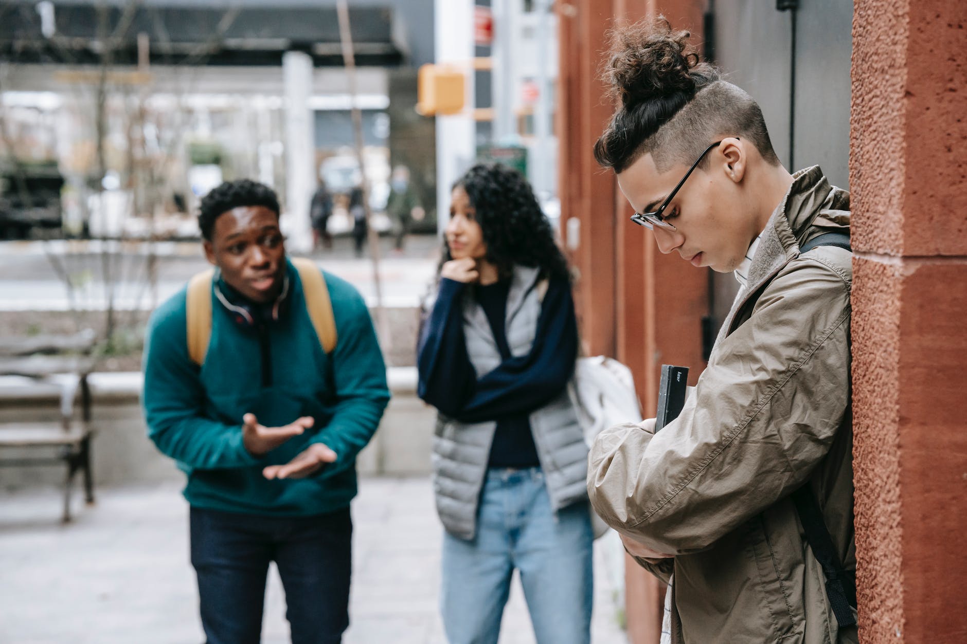 diverse friends insulting classmate on street