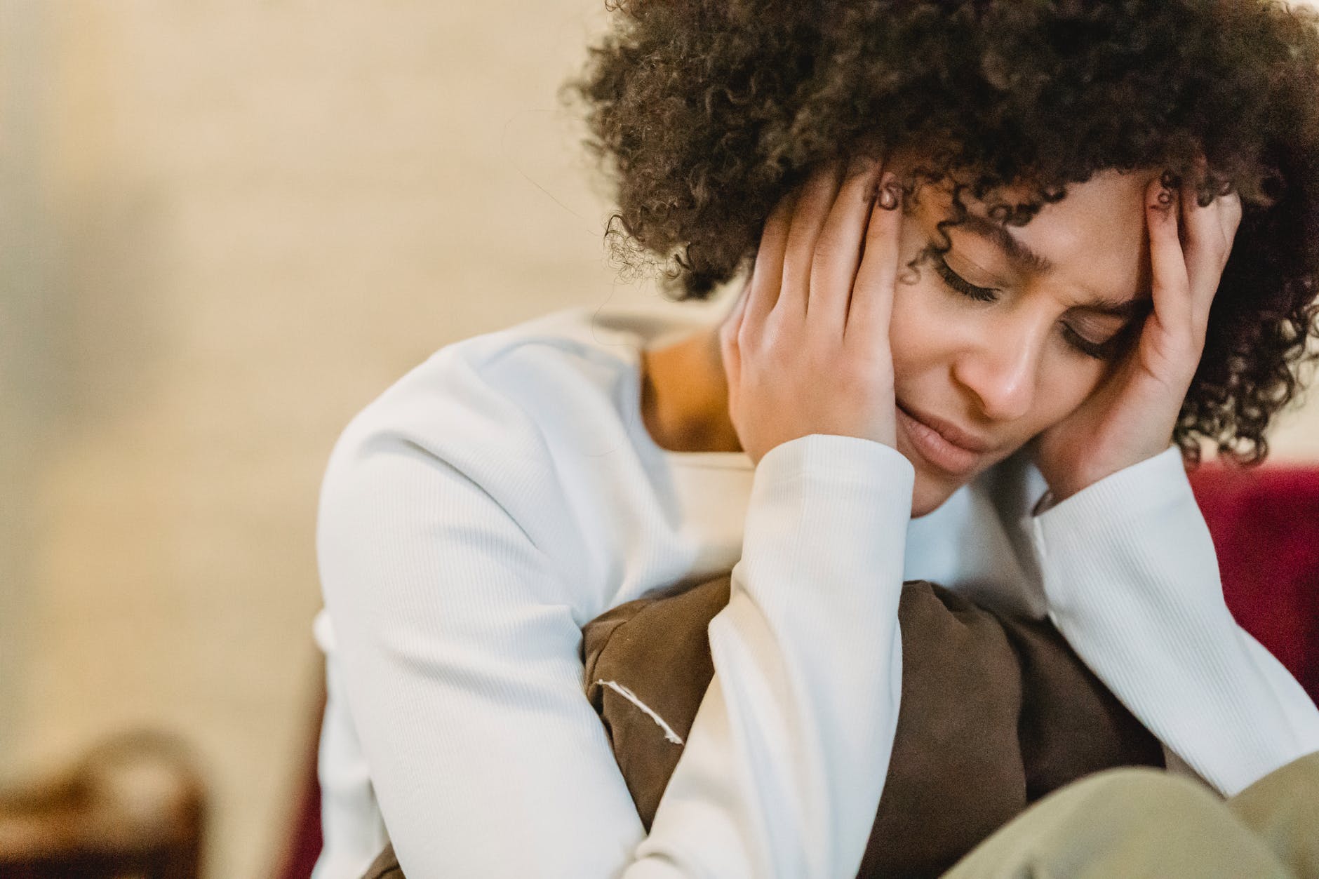 crop depressed black woman at home