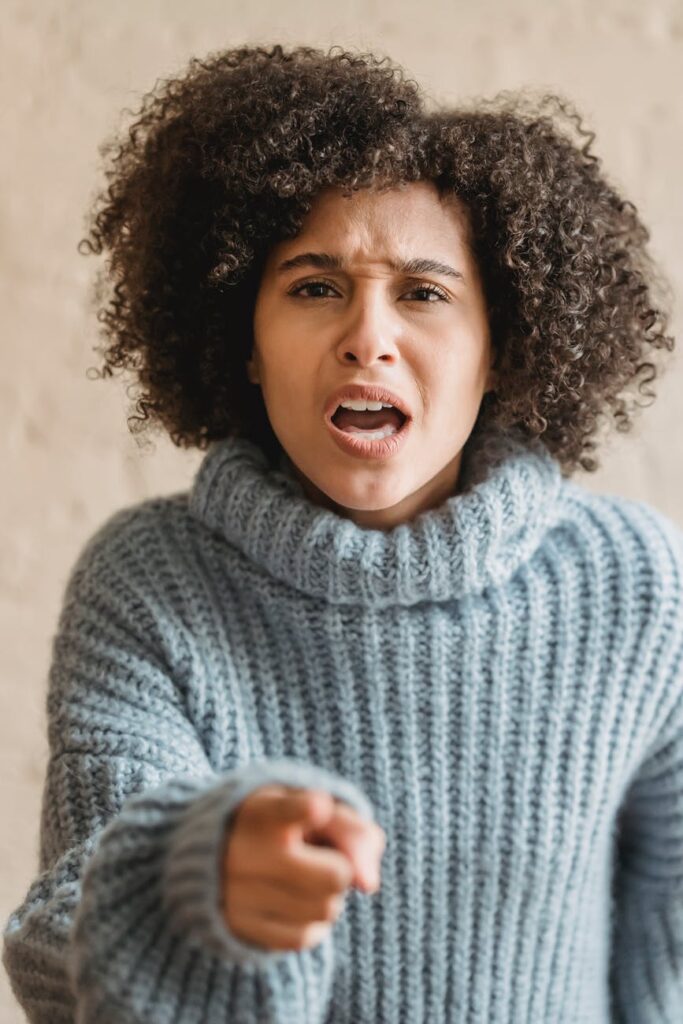 angry black woman pointing at camera