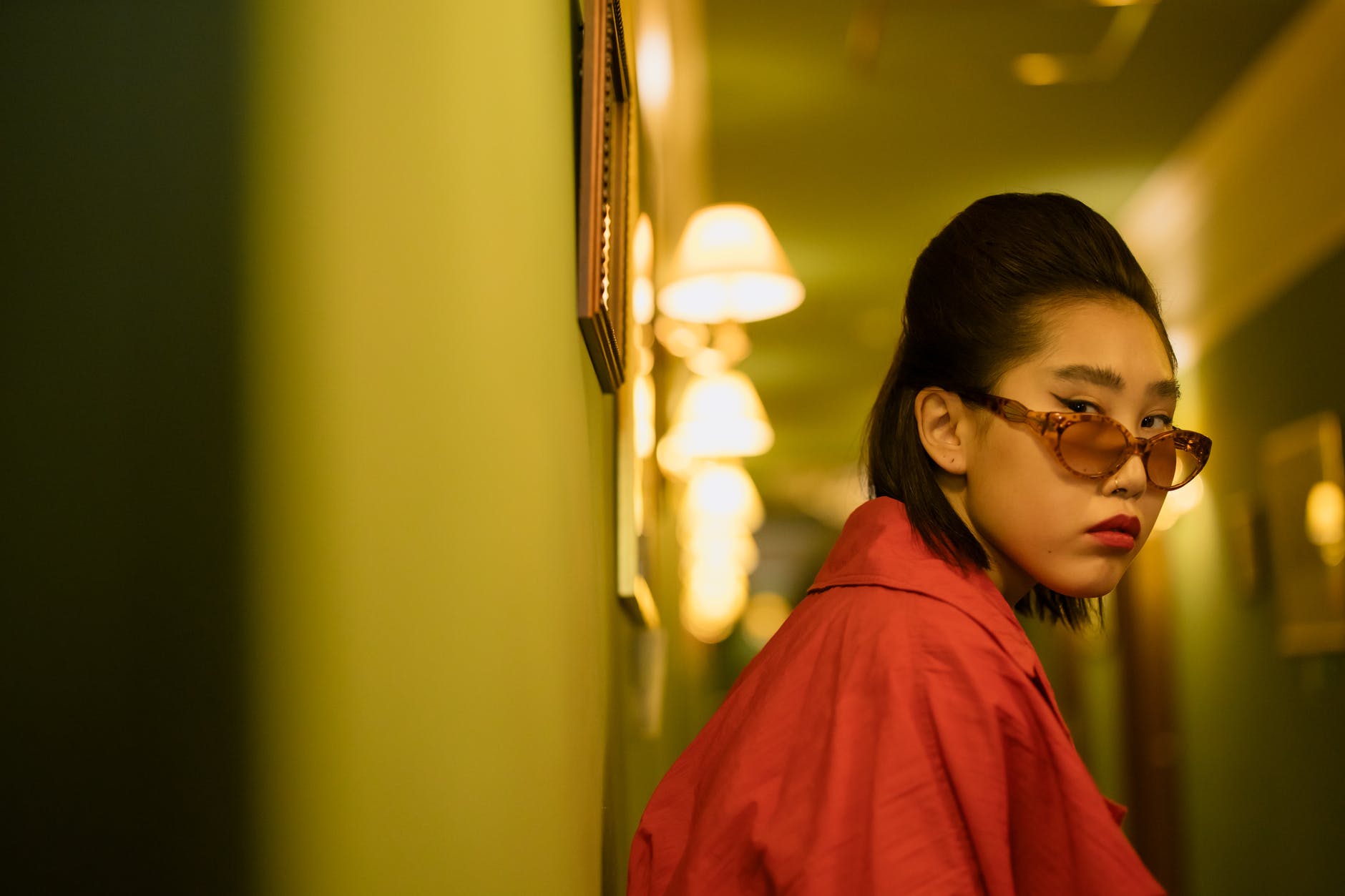 woman in red dress wearing brown framed sunglasses