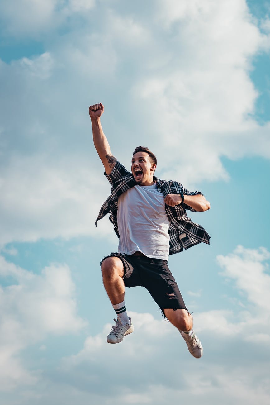 low angle photography of man jumping