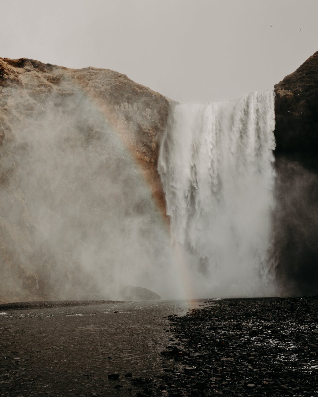 rapid waterfall falling into water