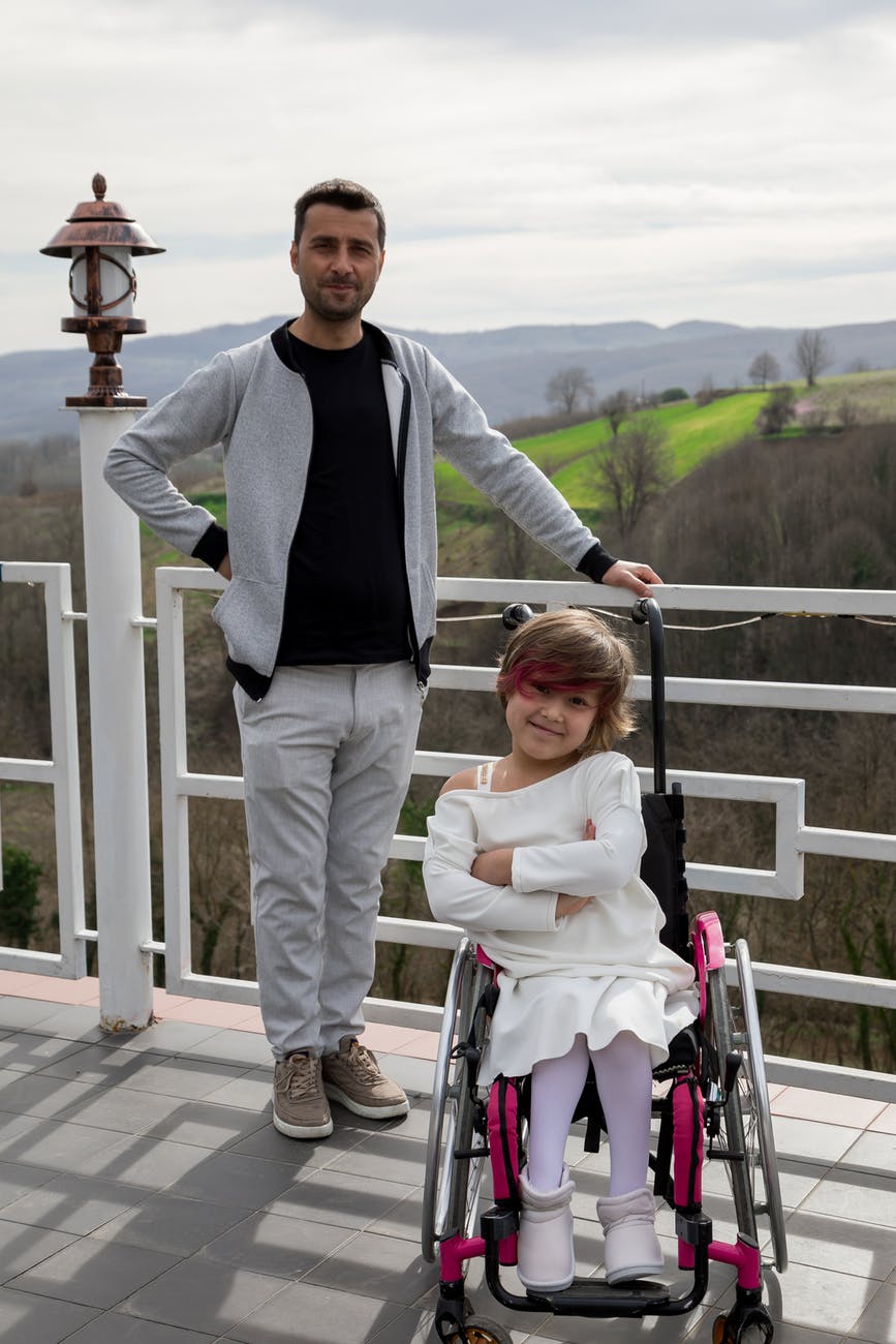 bearded father near daughter in wheelchair