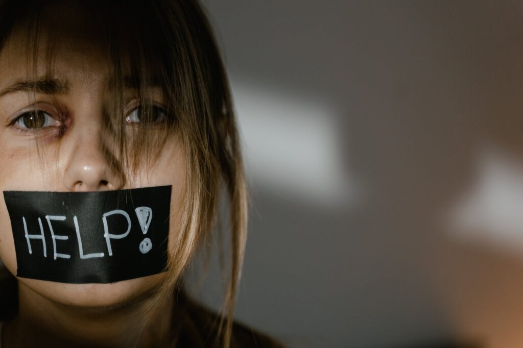 a woman with tape on her mouth