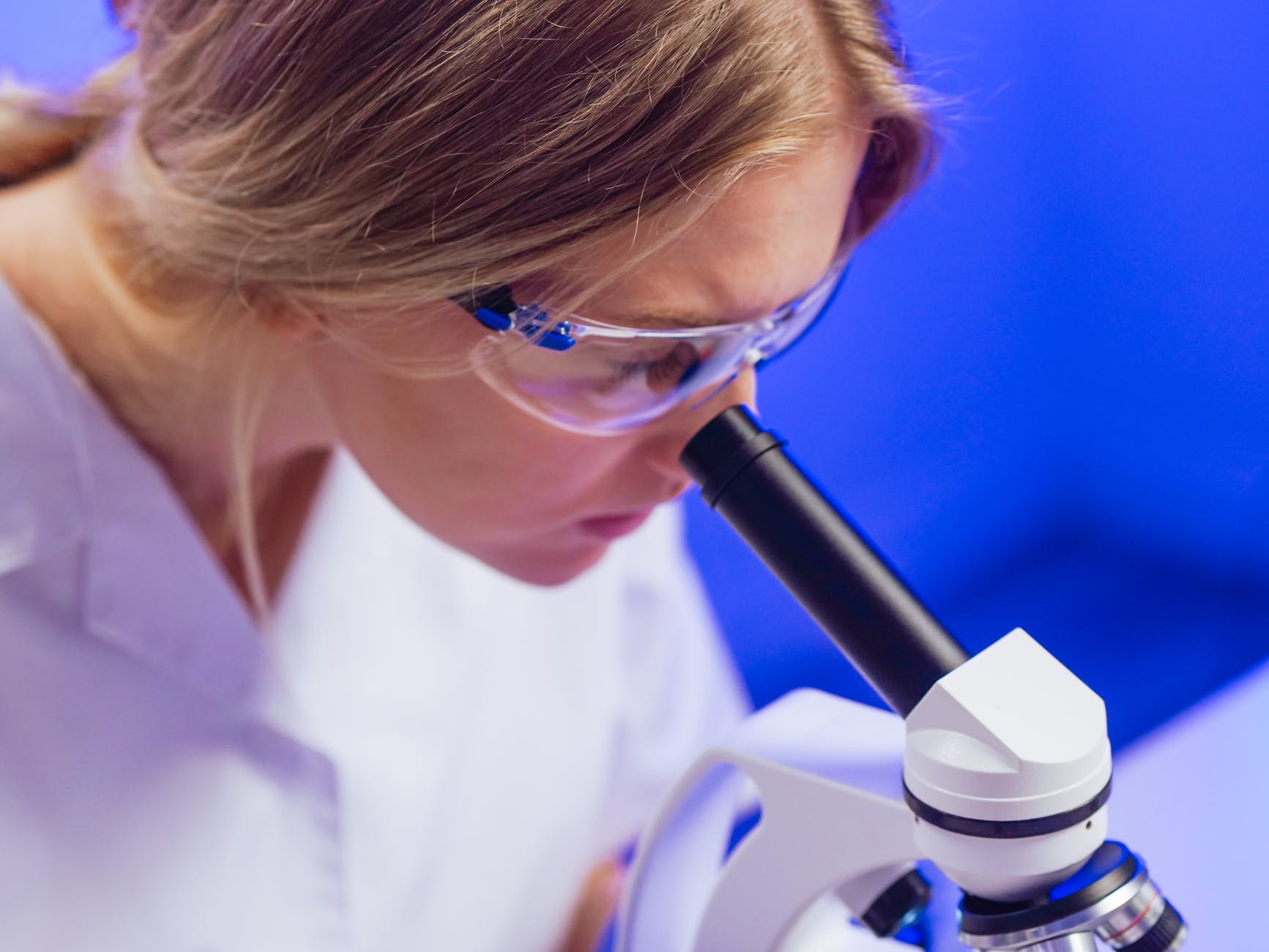 a woman looking into the microscope