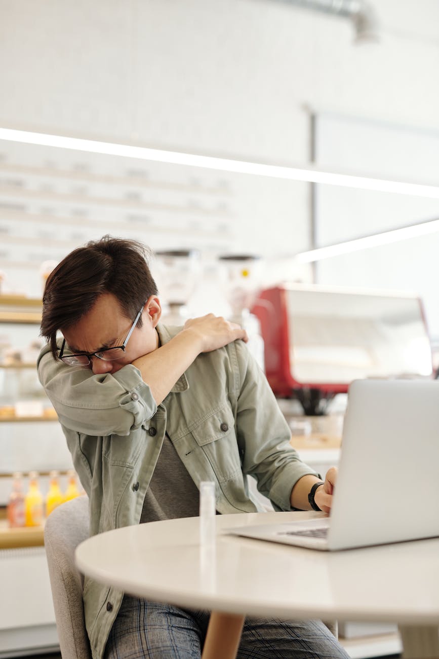 a sick man covering his mouth